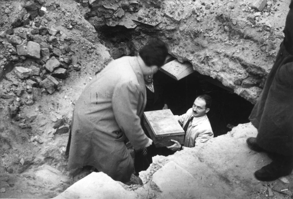 Discovering part of the Ringelblum Archives from the ruins of the Warsaw Ghetto. | Credit: Avner Shalev, Yad Vashem