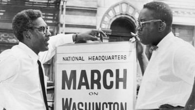 In front of 170 W 130 St., March on Washington, Bayard Rustin, Deputy Director, and Cleveland Robinson, Chairman of Administrative Committee (left to right). World Telegram & Sun photo by O. Fernandez. (Library of Congress's Prints and Photographs division)