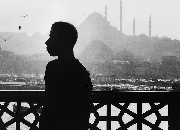 James Baldwin in 1964, against the mosques of Istanbul, Turkey. His home for a total of seven years, Istanbul was a refuge from Western racism -- and the place where he finished Another Country, Blues for Mister Charlie, and Tell Me How Long the Train's been Gone. Photo Credit: Sedat Pakay. Copyright 1989, 2013 DKDmedia