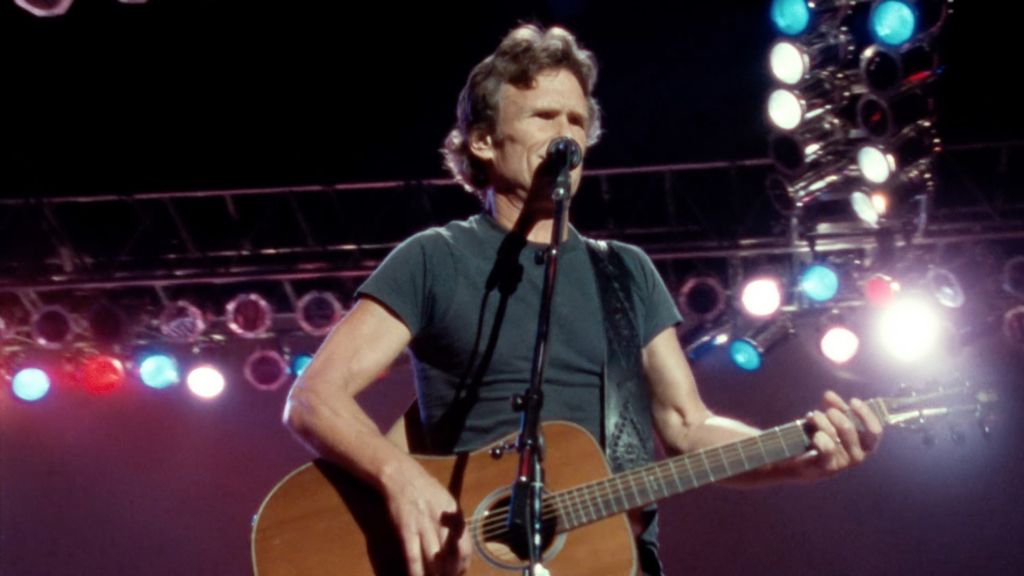 Kris Kristofferson performing at Nassau Coliseum in Uniondale, N.Y., in 1990 with The Highwaymen. Screenshot from The Highwaymen: Friends Till The End. Courtesy of Sony Music Entertainment. 