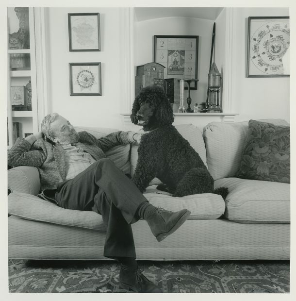 Stephen Sondheim sitting on couch with a dog.