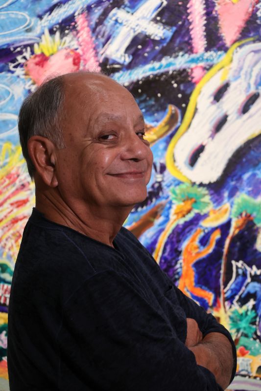 Cheech Marin in front of Leo Limon artwork.