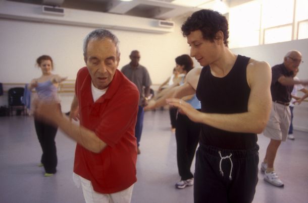 Martin Thall, member of Brooklyn Parkinson Group, dances with David Leventhal at the Mark Morris Dance Center. Photo: Katsuyoshi Tanaka.