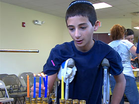 Lighting a menorah in Rabbi Bukiet's Hanukkah workshop