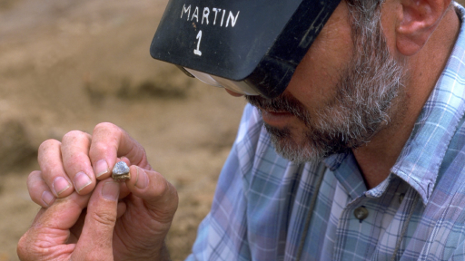 Dr. Martin Pickford examines a molar belonging to Orrorin.