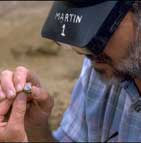 Dr. Martin Pickford examines a molar belonging to Orrorin.