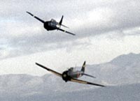 an American Grumman Wildcat flying next to a Japanese "Zero" fighter.